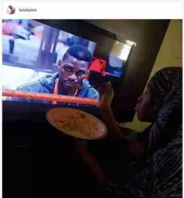 #BBNaija: Check Out How A Fan Is Feeding Tobi Through The TV; Nigerians react (Photos)